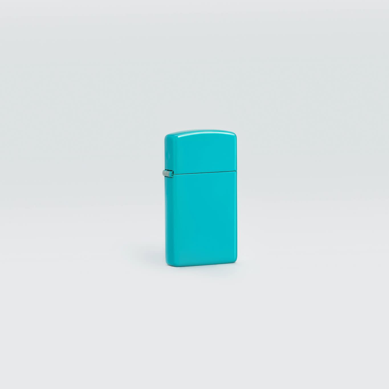 Lifestyle image of Slim?« Flat Turquoise Windproof Lighter standing in a grey scene.